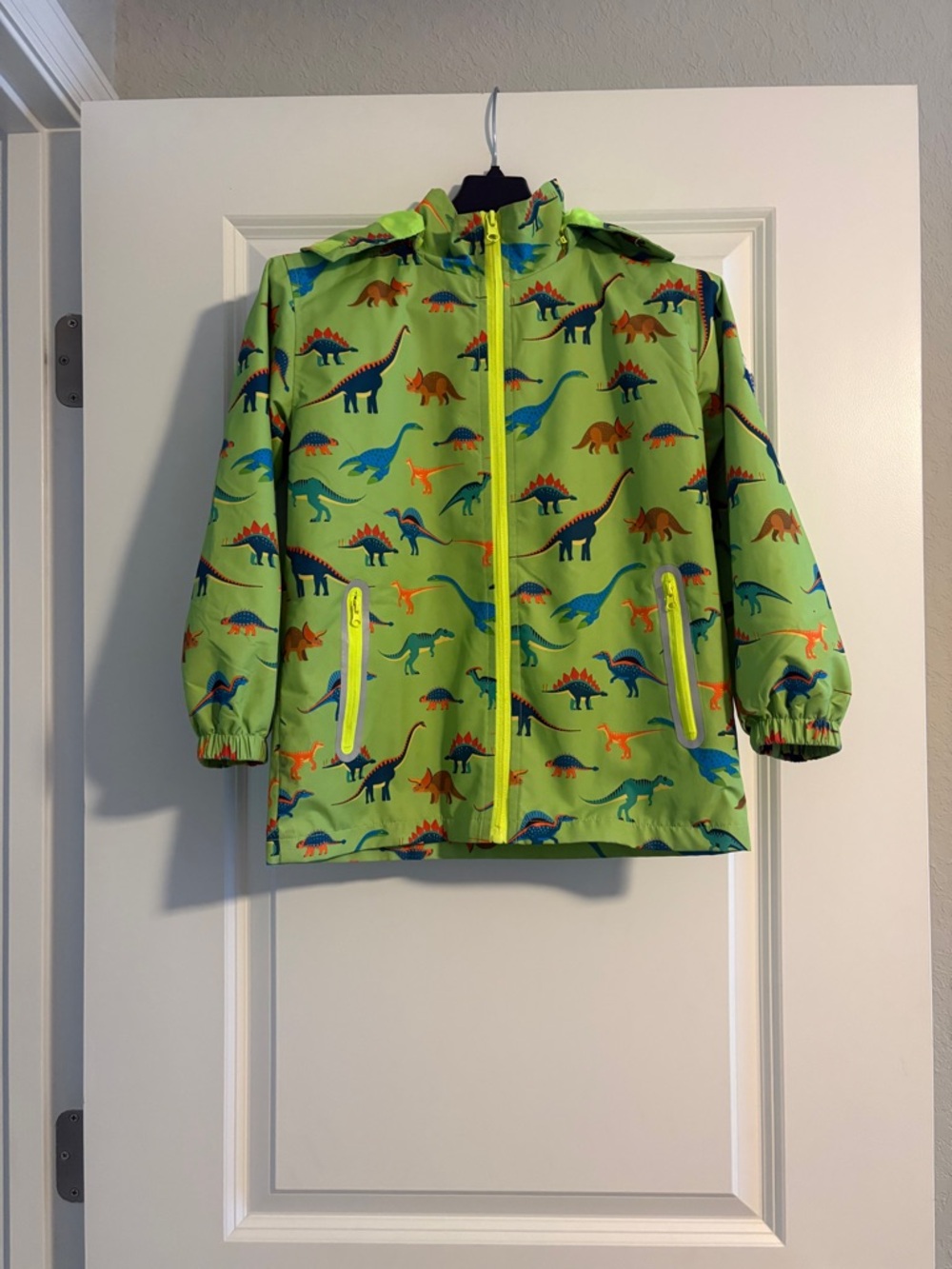 Boys rain jacket - size 6-7 green with dinosaurs and detachable hood